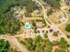 Aerial view of the neighborhood pool and clubhouse surrounded by lush trees at 27 Asti Ct, Clayton, NC 27527