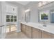 Bright bathroom featuring dual sinks, modern fixtures, and a serene view from the adjacent room at 27 Asti Ct, Clayton, NC 27527