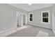 Spacious bedroom with plush carpet, two large windows, and a convenient closet at 27 Asti Ct, Clayton, NC 27527