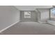 Spacious bonus room with neutral walls, carpet, and bright windows, offering versatile living space at 27 Asti Ct, Clayton, NC 27527