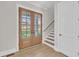 Inviting entryway showcasing beautiful double doors, hardwood floors, and a staircase at 27 Asti Ct, Clayton, NC 27527