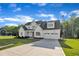 Inviting two-story home with a long driveway leading to an attached two car garage at 27 Asti Ct, Clayton, NC 27527