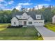 Stunning two-story home with a well-maintained lawn and an attached two car garage at 27 Asti Ct, Clayton, NC 27527