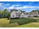 Picturesque two-story home with an expansive front lawn and an attached two car garage at 27 Asti Ct, Clayton, NC 27527