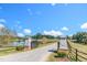 Grand gated entrance to a sprawling estate with a long driveway and scenic views of the pond and countryside at 27 Asti Ct, Clayton, NC 27527