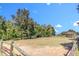 Expansive horse pasture with a wooden fence, set against a backdrop of trees and a blue sky at 27 Asti Ct, Clayton, NC 27527