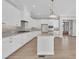 Elegant white kitchen with stainless steel appliances, large island, and modern fixtures at 27 Asti Ct, Clayton, NC 27527