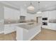 Bright kitchen features a large island, modern appliances, and ample counter space at 27 Asti Ct, Clayton, NC 27527