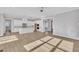 Modern open-plan kitchen with white cabinets, island, and stainless steel appliances at 27 Asti Ct, Clayton, NC 27527