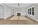 Open living area with fireplace, built-in shelves, and large picture windows at 27 Asti Ct, Clayton, NC 27527