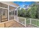 Screened-in porch overlooking the backyard, with wood flooring and steps leading to the lawn at 27 Asti Ct, Clayton, NC 27527
