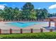 Enjoy the community swimming pool, surrounded by a fence, and lush green trees at 27 Asti Ct, Clayton, NC 27527