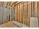 View of an unfinished bonus room showing the exposed framing and plywood sheathing at 27 Asti Ct, Clayton, NC 27527