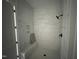 Modern bathroom featuring white marble-style tile shower with niche, bench and black fixtures at 5124 Grist Stone Way, Youngsville, NC 27596