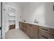 Bathroom features double vanity with stone countertops and a walk-in closet at 5124 Grist Stone Way, Youngsville, NC 27596