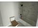 Modern bathroom featuring a tub with tiled surround and a black rainfall shower head at 5124 Grist Stone Way, Youngsville, NC 27596