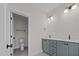 Modern bathroom with double vanity and view into a separate water closet at 5124 Grist Stone Way, Youngsville, NC 27596