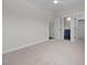Large bedroom with neutral carpet and trim and multiple doorways at 5124 Grist Stone Way, Youngsville, NC 27596