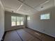 Bright bedroom with coffered ceilings and large windows, offering ample natural light at 5124 Grist Stone Way, Youngsville, NC 27596