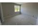 A simple bedroom showcasing a window view, awaiting personalized touches and decor at 5124 Grist Stone Way, Youngsville, NC 27596