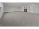 Spacious carpeted bonus room with neutral paint, fan, and access to the second floor via a doorway at 5124 Grist Stone Way, Youngsville, NC 27596