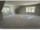 Spacious bonus room with ample natural light from the dual window set and bench seating at 5124 Grist Stone Way, Youngsville, NC 27596