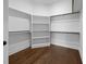 Walk-in closet with custom shelving and hardwood floors at 5124 Grist Stone Way, Youngsville, NC 27596