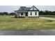 New construction home with a manicured lawn and landscaping and a covered porch at 5124 Grist Stone Way, Youngsville, NC 27596