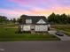 Beautiful home featuring a lush front yard, and a covered front porch and a long driveway at 5124 Grist Stone Way, Youngsville, NC 27596