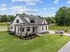 Inviting two-story home with a cozy front porch, well-kept lawn, and convenient side entry garage at 5124 Grist Stone Way, Youngsville, NC 27596