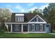 Illustration of a charming two-story home with a covered front porch and neatly landscaped yard at 5124 Grist Stone Way, Youngsville, NC 27596