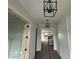 Foyer with paneled walls, modern light fixtures, and an open doorway leading to additional rooms at 5124 Grist Stone Way, Youngsville, NC 27596