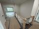 Hallway with wooden staircase featuring white wooden balusters at 5124 Grist Stone Way, Youngsville, NC 27596