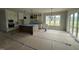 Bright, open-concept kitchen with a center island, white cabinets, and stainless steel appliances at 5124 Grist Stone Way, Youngsville, NC 27596