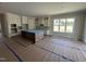 Spacious kitchen with a large island, shaker cabinets and stainless-steel appliances at 5124 Grist Stone Way, Youngsville, NC 27596