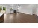 Spacious living room with hardwood floors, a fireplace, built-in cabinets, and access to an outdoor deck at 5124 Grist Stone Way, Youngsville, NC 27596