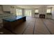 Open-concept kitchen and living room layout, featuring an island, fireplace, and access to the porch at 5124 Grist Stone Way, Youngsville, NC 27596