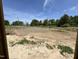 New construction lot ready for building with a backdrop of trees and blue skies at 5124 Grist Stone Way, Youngsville, NC 27596