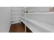 Walk-in pantry offering ample storage with floor-to-ceiling shelves and hardwood flooring at 5124 Grist Stone Way, Youngsville, NC 27596