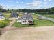 Aerial view of house and property highlighting backyard space, green grass, and a new construction development at 5124 Grist Stone Way, Youngsville, NC 27596