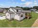 Aerial view of a new construction home with a screened-in porch, manicured lawn, and white exterior at 5124 Grist Stone Way, Youngsville, NC 27596