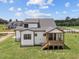 Aerial view of home featuring a modern porch, well-kept lawn and a contrasting color scheme at 5124 Grist Stone Way, Youngsville, NC 27596