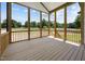 Screened porch with wood floors and scenic backyard views of greenery, trees, and fence at 5124 Grist Stone Way, Youngsville, NC 27596