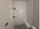 New shower with white subway tile, built-in bench, and black showerhead at 5124 Grist Stone Way, Youngsville, NC 27596