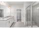 Bright bathroom with granite countertops, a glass-enclosed shower, and white cabinetry at 1024 Jarrett Bay Rd, Willow Springs, NC 27592