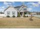 Traditional two-story home featuring a charming front porch and well-maintained landscaping at 1024 Jarrett Bay Rd, Willow Springs, NC 27592