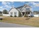 Charming two-story home with a welcoming front porch and manicured lawn at 1024 Jarrett Bay Rd, Willow Springs, NC 27592