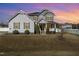 Two-story home featuring a welcoming front porch and well-manicured lawn at 1024 Jarrett Bay Rd, Willow Springs, NC 27592