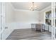 Home office with wood-look flooring, a large window and french doors to the foyer at 1024 Jarrett Bay Rd, Willow Springs, NC 27592