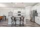 Bright kitchen featuring white cabinets, stainless steel appliances, granite counters, and pendant lighting at 1024 Jarrett Bay Rd, Willow Springs, NC 27592